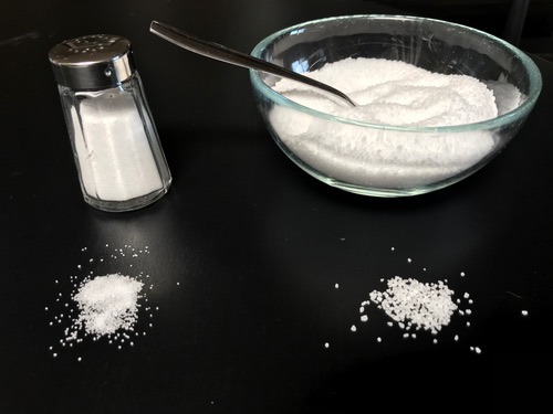 Table salt (left) often has iodine or anti-caking agents added; plain coarse salt (right) is the safer type.