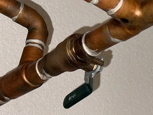 Copper plumbing. Run the tap for a minute before filling buckets for the tank.