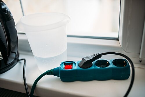 Water next to a power strip: keep plugs and strips above and away from any splash or drip.