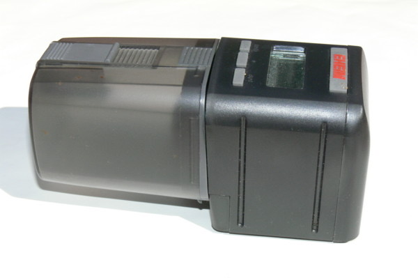 A battery automatic feeder. Test it for a week before you leave.